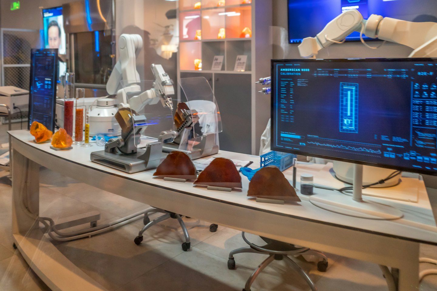 Robotic arm works with scientific instruments on a lab bench.